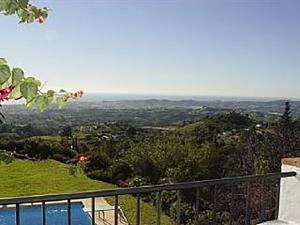 a view of a valley from a balcony of a house at Villa El Capricho in Mijas