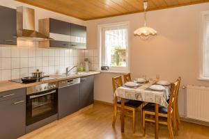a kitchen with a table with chairs and a dining room at Ferienanlage Seefeldt in Freest