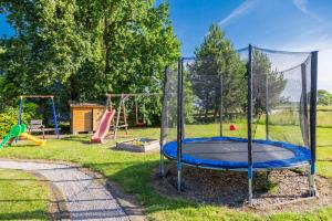 a playground with a trampoline in a park at Ferienanlage Seefeldt in Freest