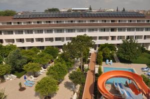 a large building with a swimming pool and a resort at Catty Cats Garden Hotel in Side