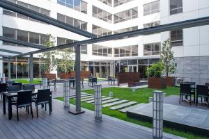 a patio with tables and chairs in a building at ISG Sabiha Gökçen Airport Hotel in Istanbul