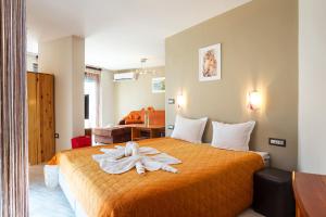 a room with a bed with a towel on it at ApartHotel Prostor in Kavarna +58 photos