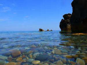 uma vista para o oceano com pedras na água em Casa al mare em Tusa