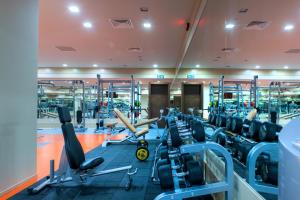 a gym with a lot of cardio equipment at ISG Sabiha Gökçen Airport Hotel in Istanbul