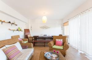 a living room with a couch and chairs and a table at Marathon Beachside Villa 100m from the beach in Schinias