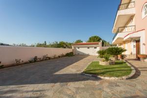a driveway of a house with a garage at Marathon Beachside Villa 100m from the beach in Schinias