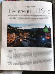 a page of a magazine with a picture of a city at Civico 27 in Cosenza