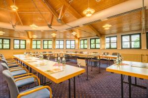 a large dining room with tables and chairs at Grandhotel Esplanade in Bad Nenndorf