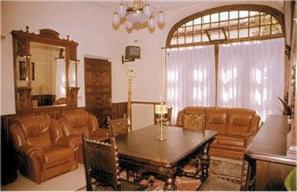a living room with a table and a couch at Casa España in Villaviciosa