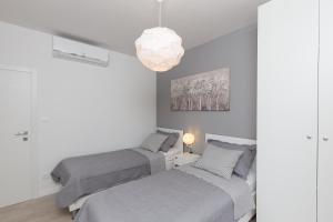 A bed or beds in a room at Apartments Venka