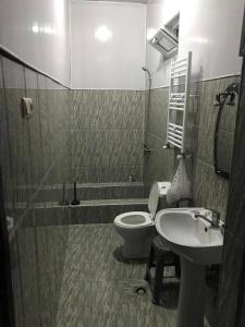 a bathroom with a toilet and a sink at Seaside House Kobuleti in K'obulet'i