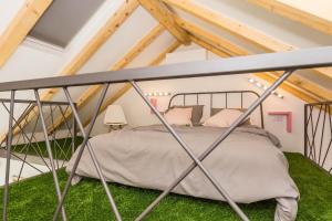 a bedroom with a metal bed in a attic at Apartment Shiny Love in Split