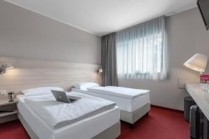 Postel nebo postele na pokoji v ubytování Serways Hotel Spessart