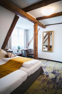 a bedroom with a large bed and a table at Hotel Zirbelstube in Nuremberg