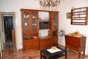 a living room with a tv and a dresser at Casa Vacanze Da Nonna Maria in Guardiagrele