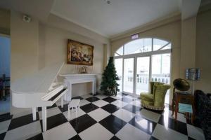 a living room with a white piano and a christmas tree at Empire Pacific Castle in Yangmei