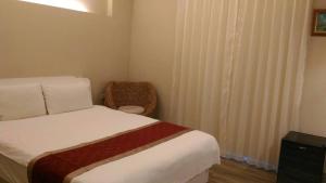 君洋飯店Co-Living Hotel 龍潭科學園區 楊梅幼獅 月租旅居共生宅客房内的一张或多张床位