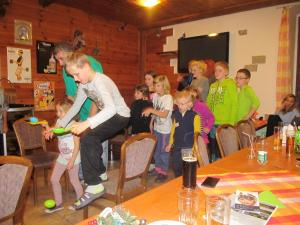 a man playing a game with a group of children at Penzion Rudolf in Liberec