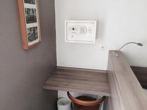a bathroom with a wooden counter and a microwave at Hotel Cosmos in Paris