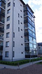 a tall white building with windows on the side of it at New nice apartment in Vaasa