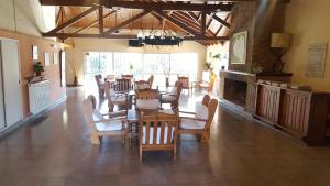 a dining room with tables and chairs and a fireplace at Hotel Agustin Garcia in Tigre