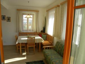 a dining room with a table and a couch at Gästehaus Lisa in Deutschlandsberg