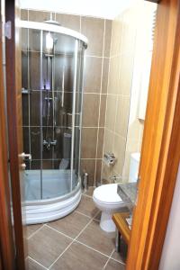 a bathroom with a shower and a toilet at Izmıt Saray Hotel in Kocaeli