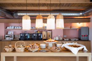 a kitchen with a table with baskets of food at Hostal la Savina in La Savina