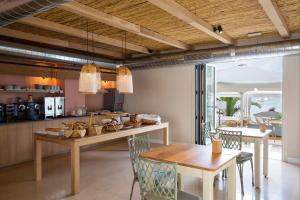 a kitchen with a table and chairs and a dining room at Hostal la Savina in La Savina