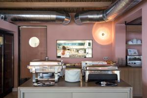 a restaurant kitchen with a counter with several dishes at Hostal la Savina in La Savina
