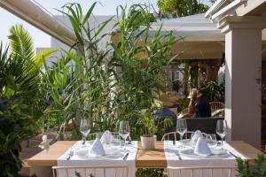 a table with glasses and napkins on top of it at Hostal la Savina in La Savina