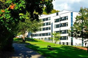 a white building with a park in front of it at Juniper Court in Stirling