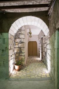 CaltabellottaにあるCasa Arco Anticoの石造りの建物内の扉付きアーチ道