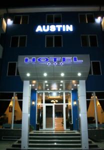 a blue building with a sign for a hotel at Hotel Austin in Constanţa