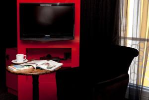 a tv sitting on top of a wooden table at Hypnos Design Hotel in Istanbul