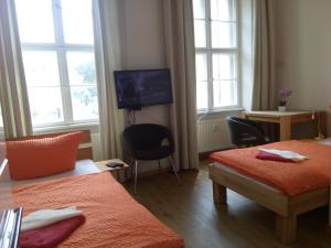 Ένα ή περισσότερα κρεβάτια σε δωμάτιο στο Apartmentpension am Stadtschloss