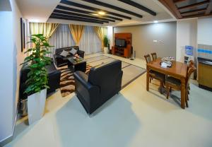 a living room with a couch and a table at Sea Diamond Plaza Apartments in Manama