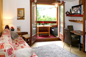 a bedroom with a bed and a desk and a window at Studio Résidence Glières in Bourg-Saint-Maurice