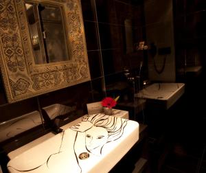a bathroom with a bathtub, sink, and mirror at Hypnos Design Hotel in Istanbul