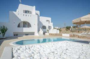 a villa with a swimming pool and a house at Plaka Collection in Plaka