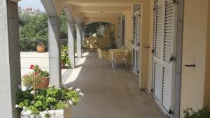 an internal courtyard of a house with a table and chairs at Apartmani More in Sveti Stefan
