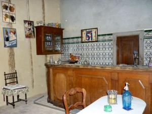 a kitchen with a counter and a table with a bottle on it at Château de Vallègue in Vallègue +48 photos