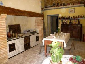 a kitchen with a table and a stove in a room at Château de Vallègue in Vallègue