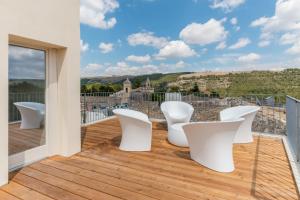 two white toilets sitting on top of a wooden deck at Terrazza Dei Sogni in Ragusa