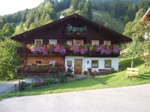 a house with flowers on the side of it at Ferienhaus Grubhof in Saalbach Hinterglemm