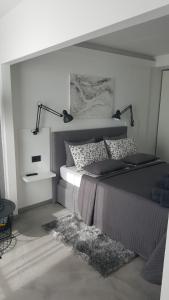 a bedroom with a bed with two lamps and a rug at Apartman VIP, with Free Garage Parking in Pula