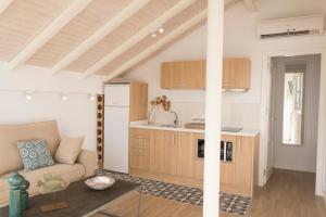 a living room with a couch and a kitchen at Living4Malaga Atico Cervantes in Málaga