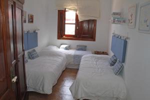 a group of three beds in a room at Villas Macher in Tías