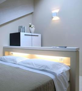 A bed or beds in a room at Albergo Silvio