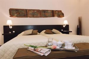 a hotel room with two beds and a tray of food at Ucciardhome Hotel in Palermo